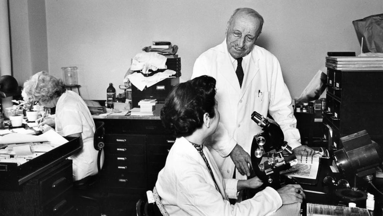 Dr. George N. Papanicolaou, co-founder of the Greek-American Medical Fraternity and of HMS, in his laboratory at Cornell.