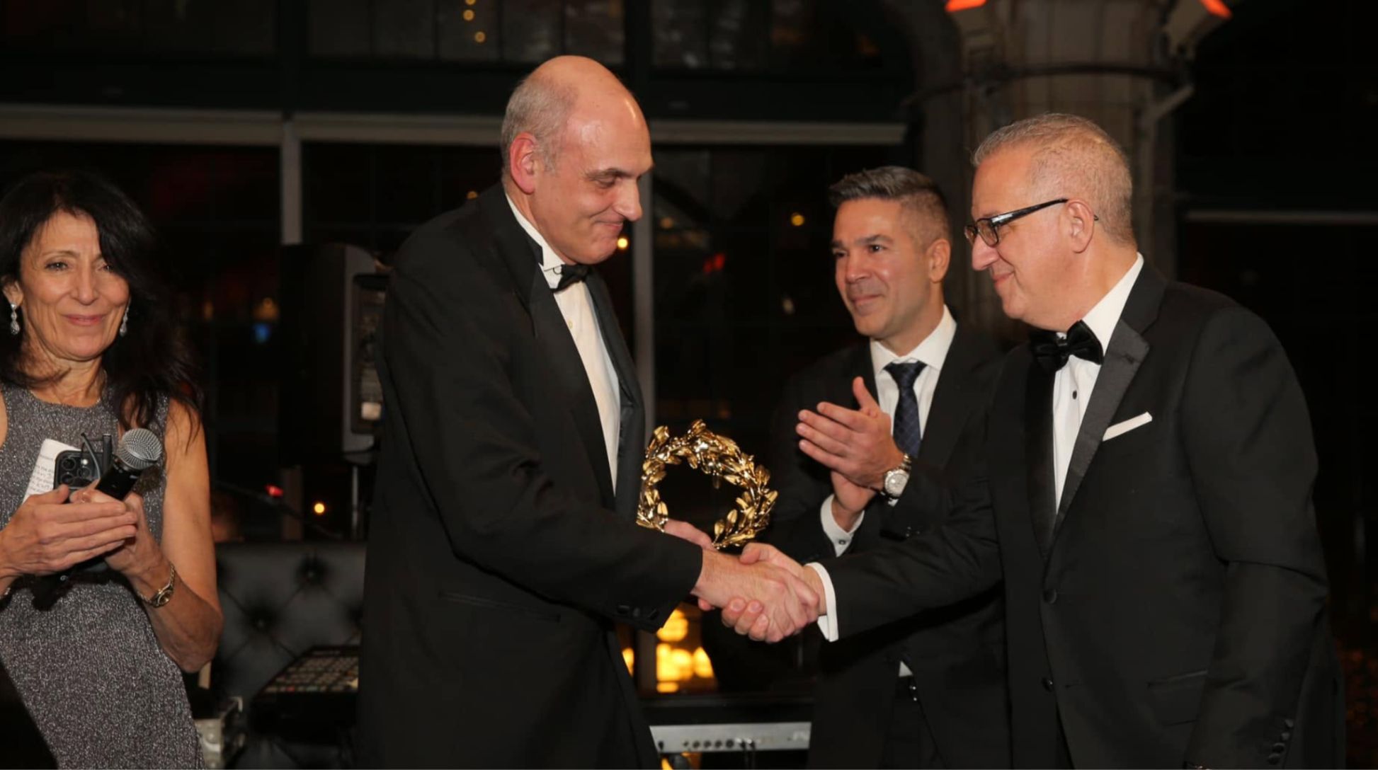 A gala honoree receives the golden laurel.