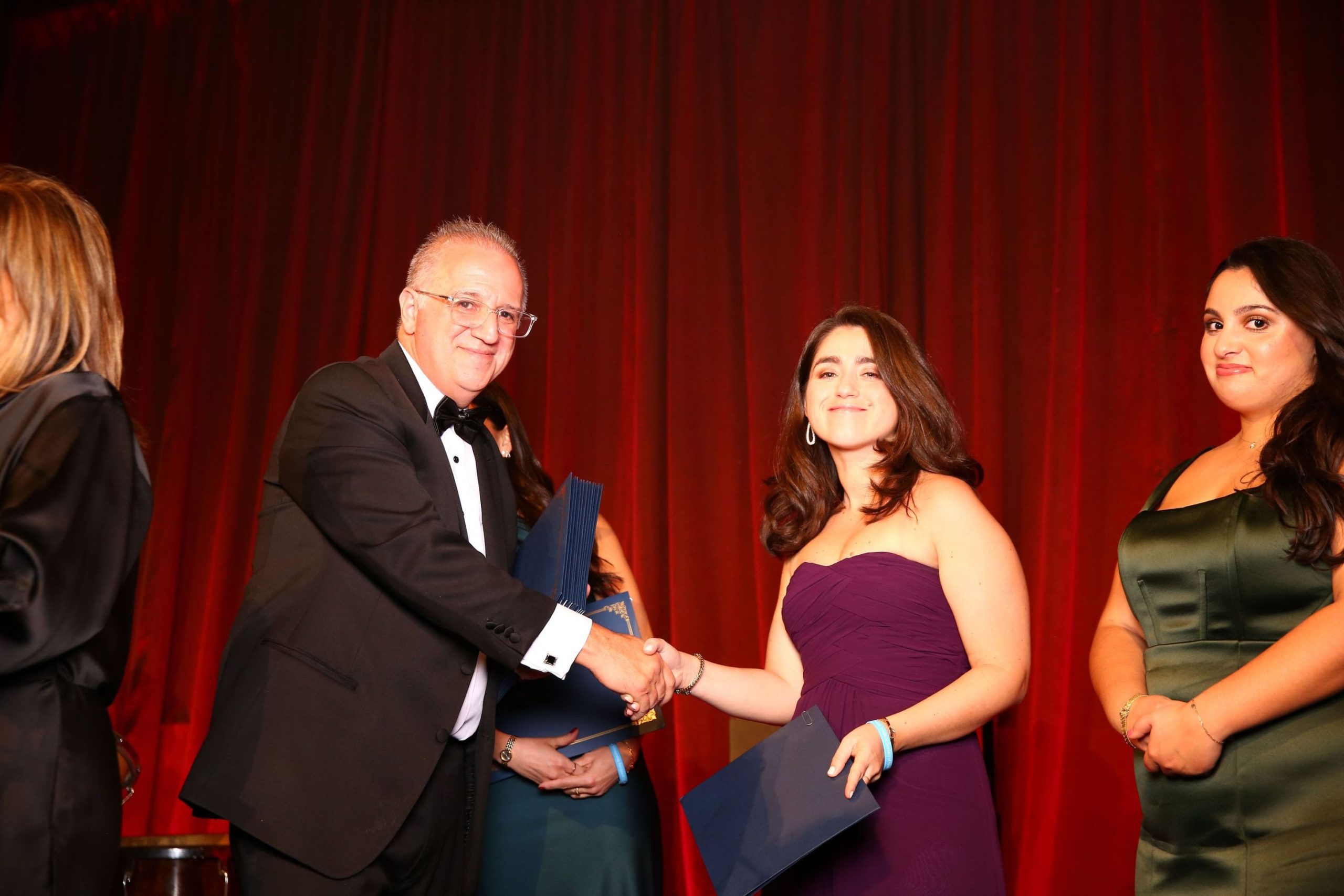A scholarship recipient receives her award.