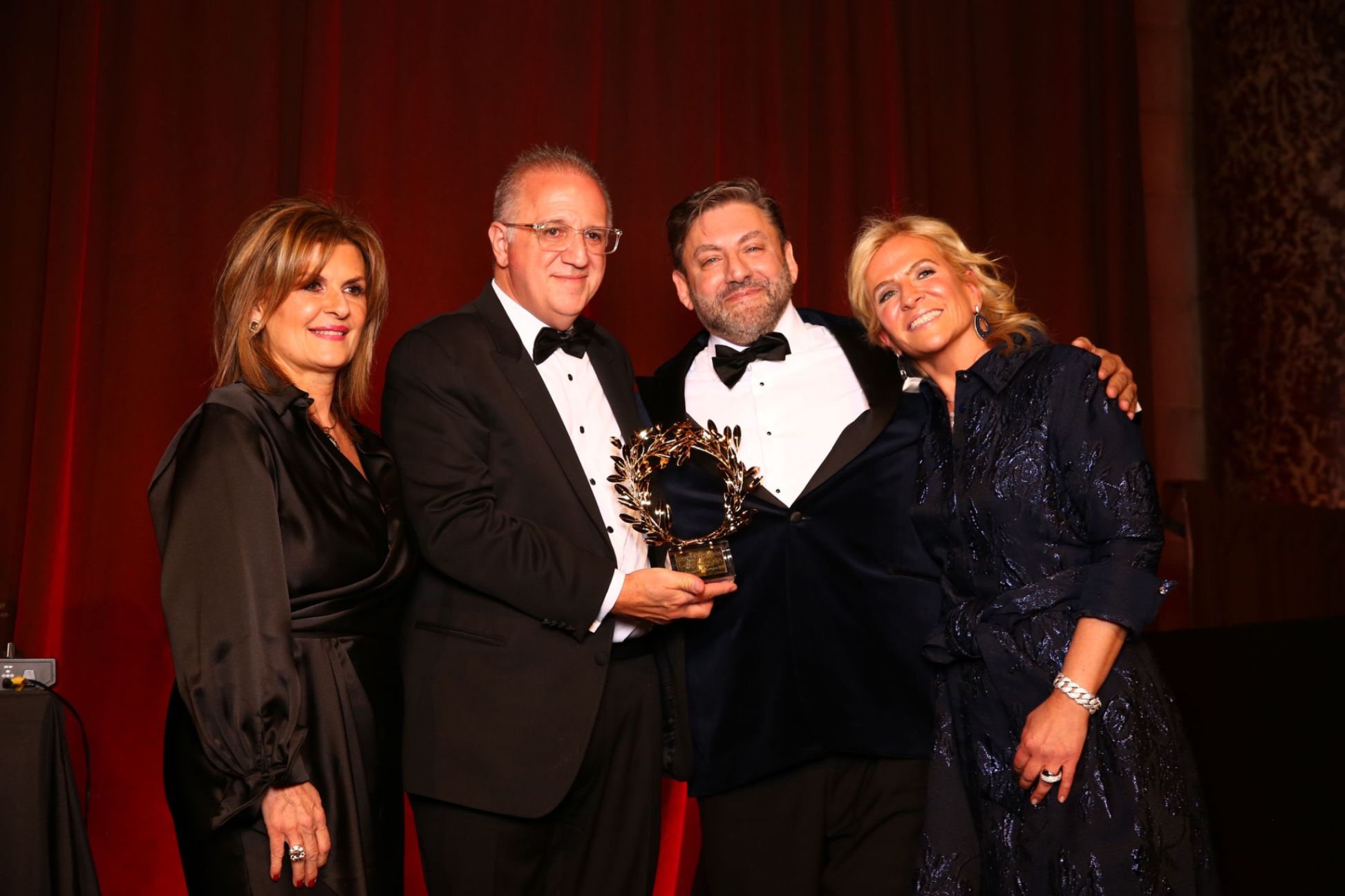 A heartfelt moment of pride as Dr. George Liakeas receives the 2025 Distinguished Colleague Award from Dr. Eleni Gouzoulis-Koutsos and Dr. Antonios Gasparis, and celebrates with his wife Nicole Contos-Liakeas.