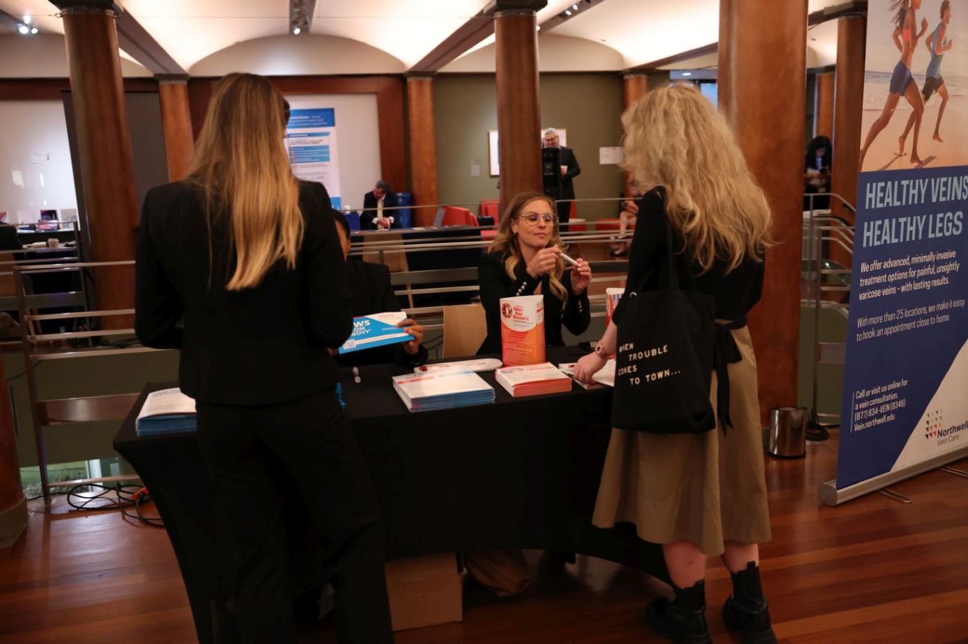 Attendees visit the exhibitor booths.