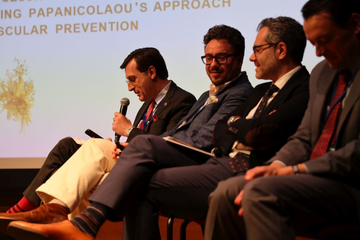 Dr. George Dangas, Dr. Stavros Zanos, Dr. Theodoros Zanos, and Dr. Stavros Mountantonakis on stage.