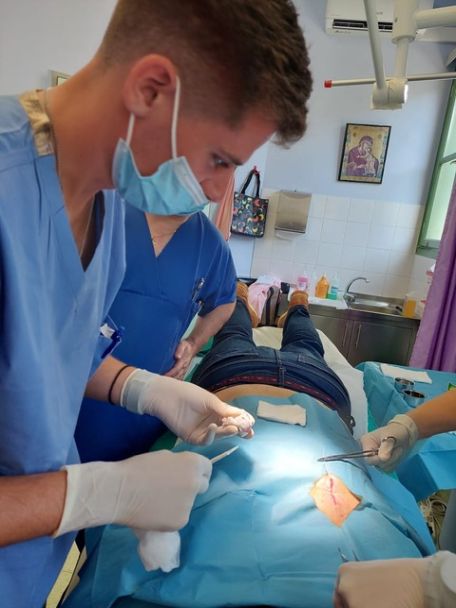 A young HMS physician in surgery during a medical mission